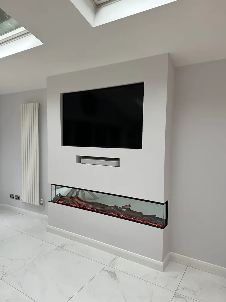 Media wall with concealed power, a wall mounted television and an inset electric fire by HC Pyramid Electrical LTD