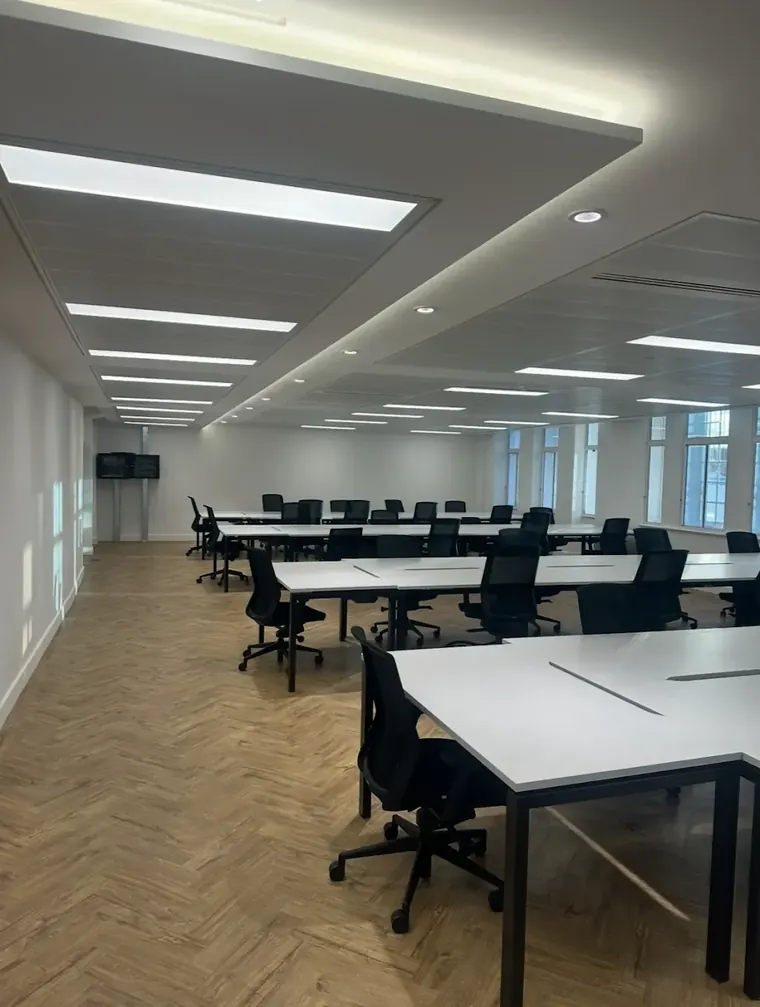 Commercial office with linear LED lighting and herringbone flooring, wired by HC Pyramid Electrical LTD