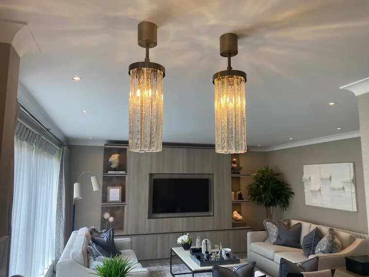 Finished apartment living space with feature pendant lighting and recessed downlights, rewired by HC Pyramid Electrical LTD